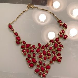 gold chain necklace with red stones.